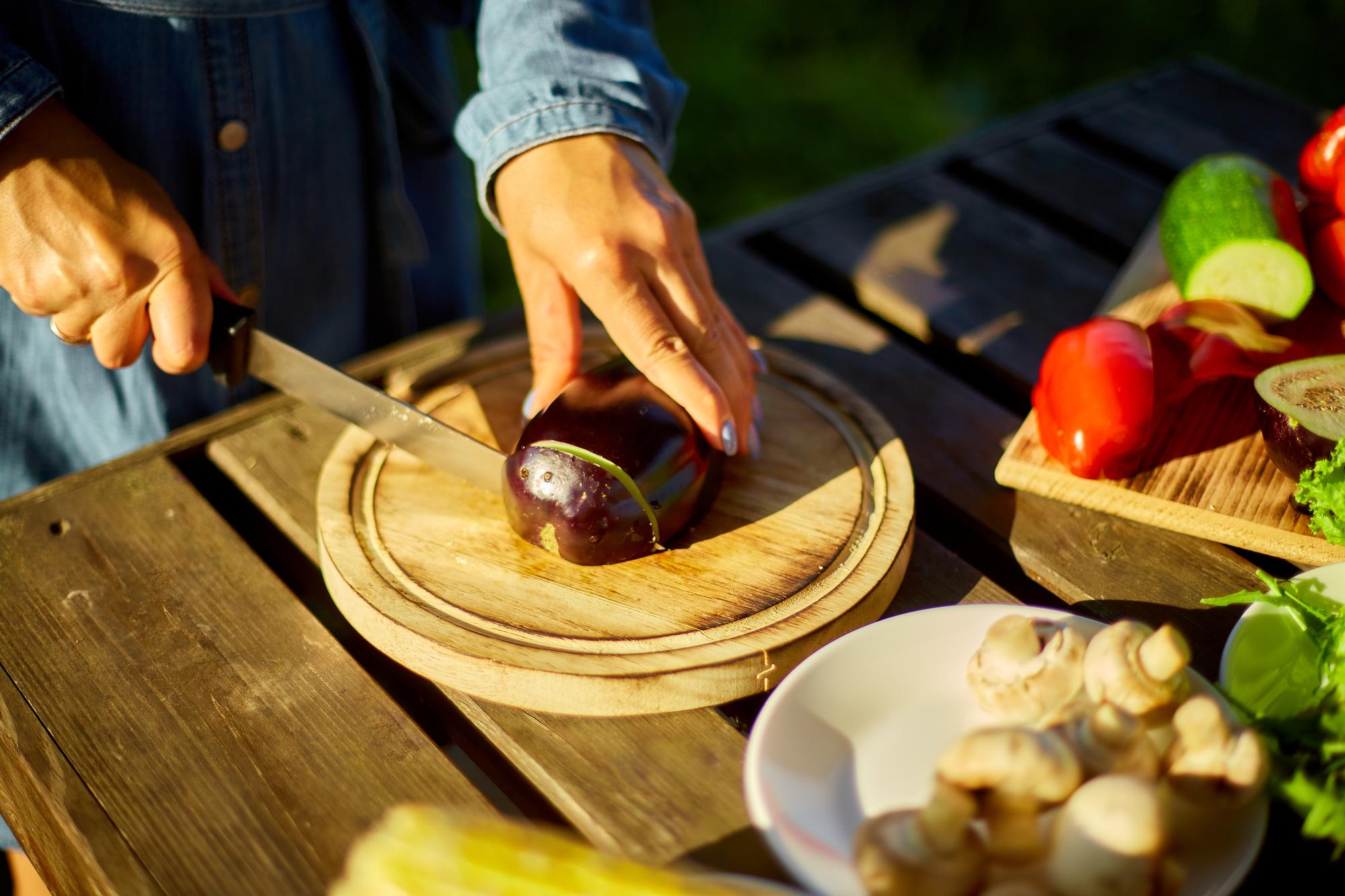 chef arranging rustic dish on wooden table